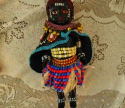 7" HARD PLASTIC AFRICAN TRIBAL BUGUSU WOMAN DOLL, HEAVILY BEADED, LEATHER CAPE